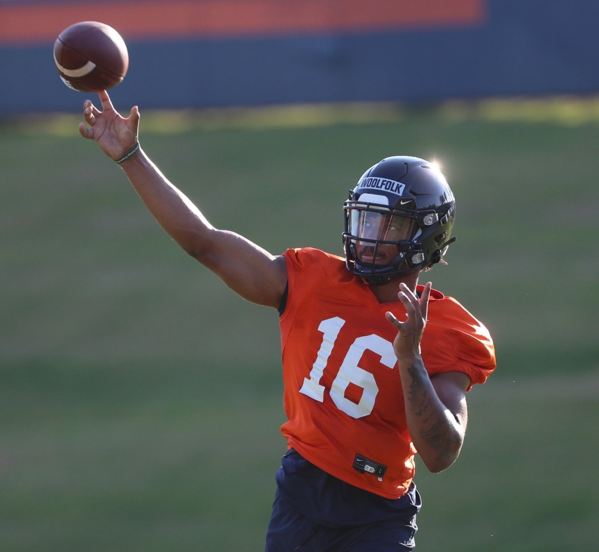 Virginia quarterback Jay Woolfolk throws a pass during UVA fall camp.